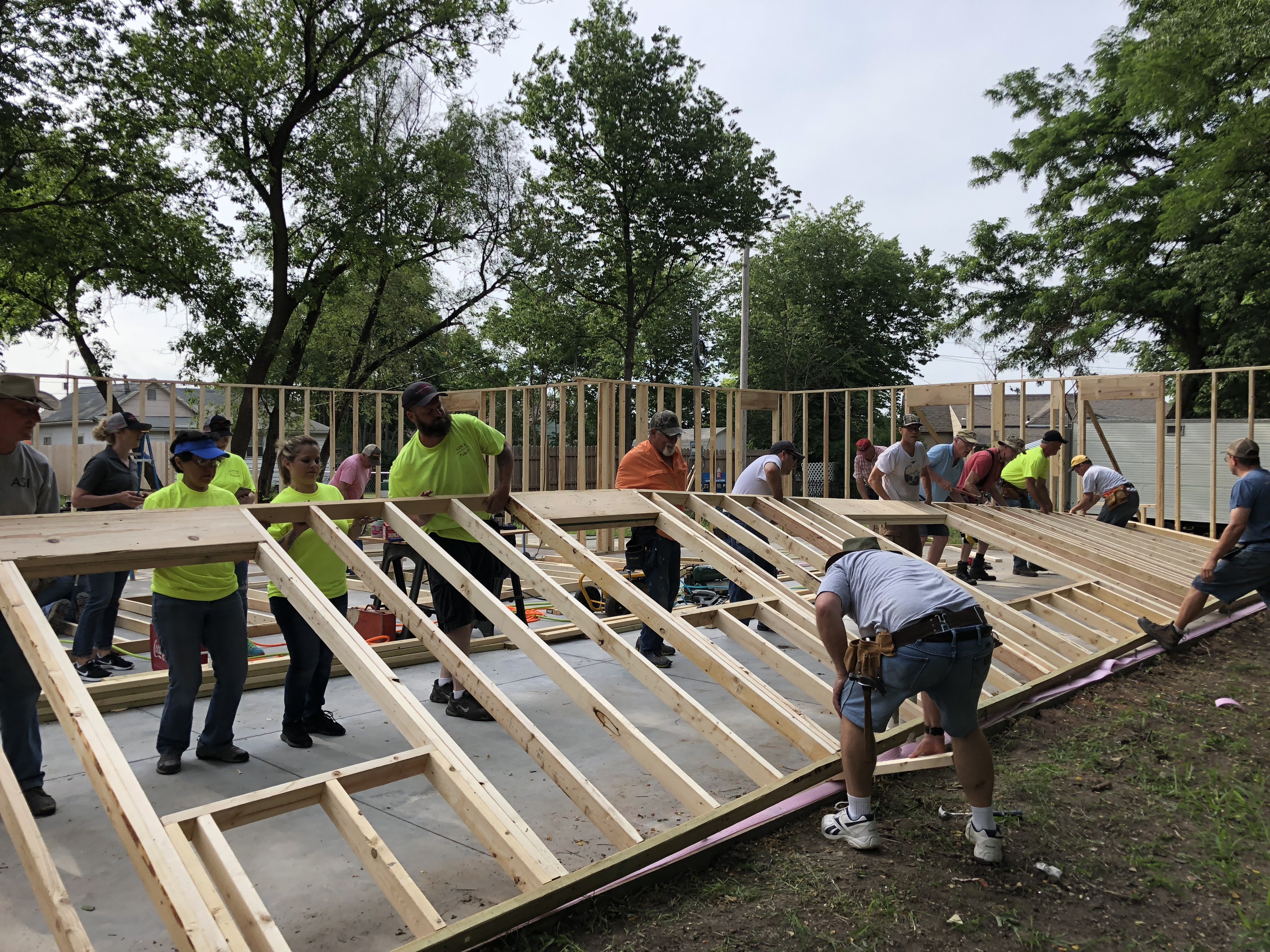 Volunteers lifting framing